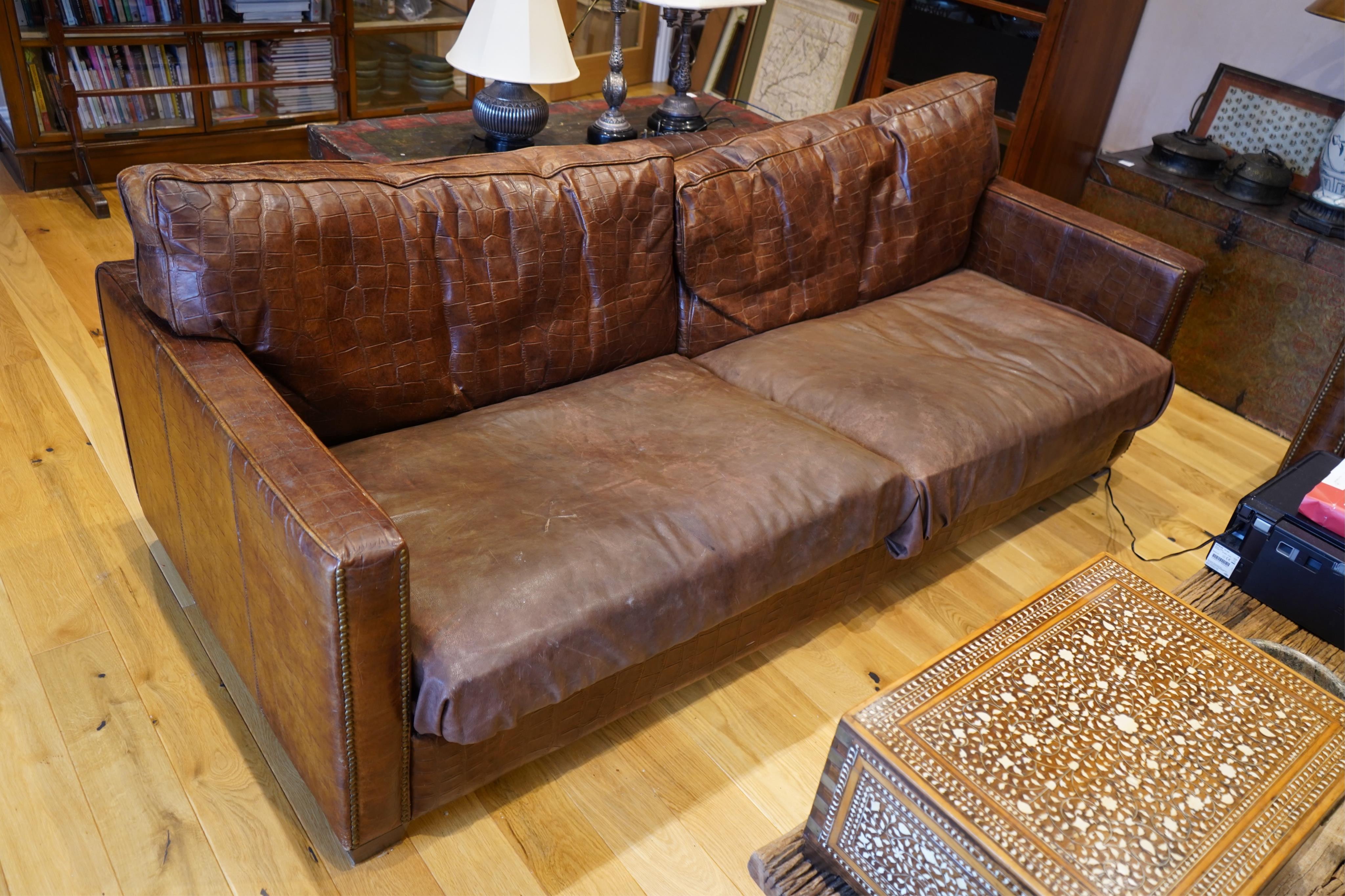 Andrew Martin Viscount William mock crocodile settee by Timothy Oulton with later leather hide covers, width 223cm, depth 98cm, height 88cm. Condition - poor